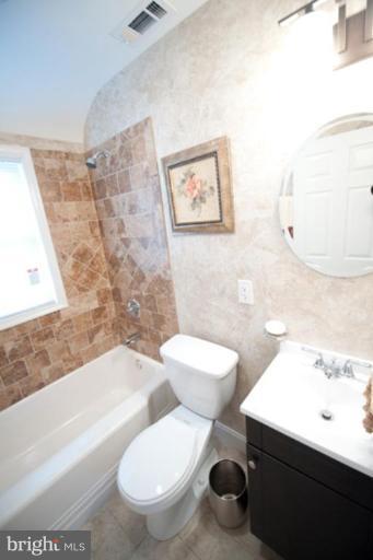 3127 Sollers Point Road Dundalk, MD 21222 - Photo 6 of 14 a white toilet sitting next to a bathroom sink and a tub