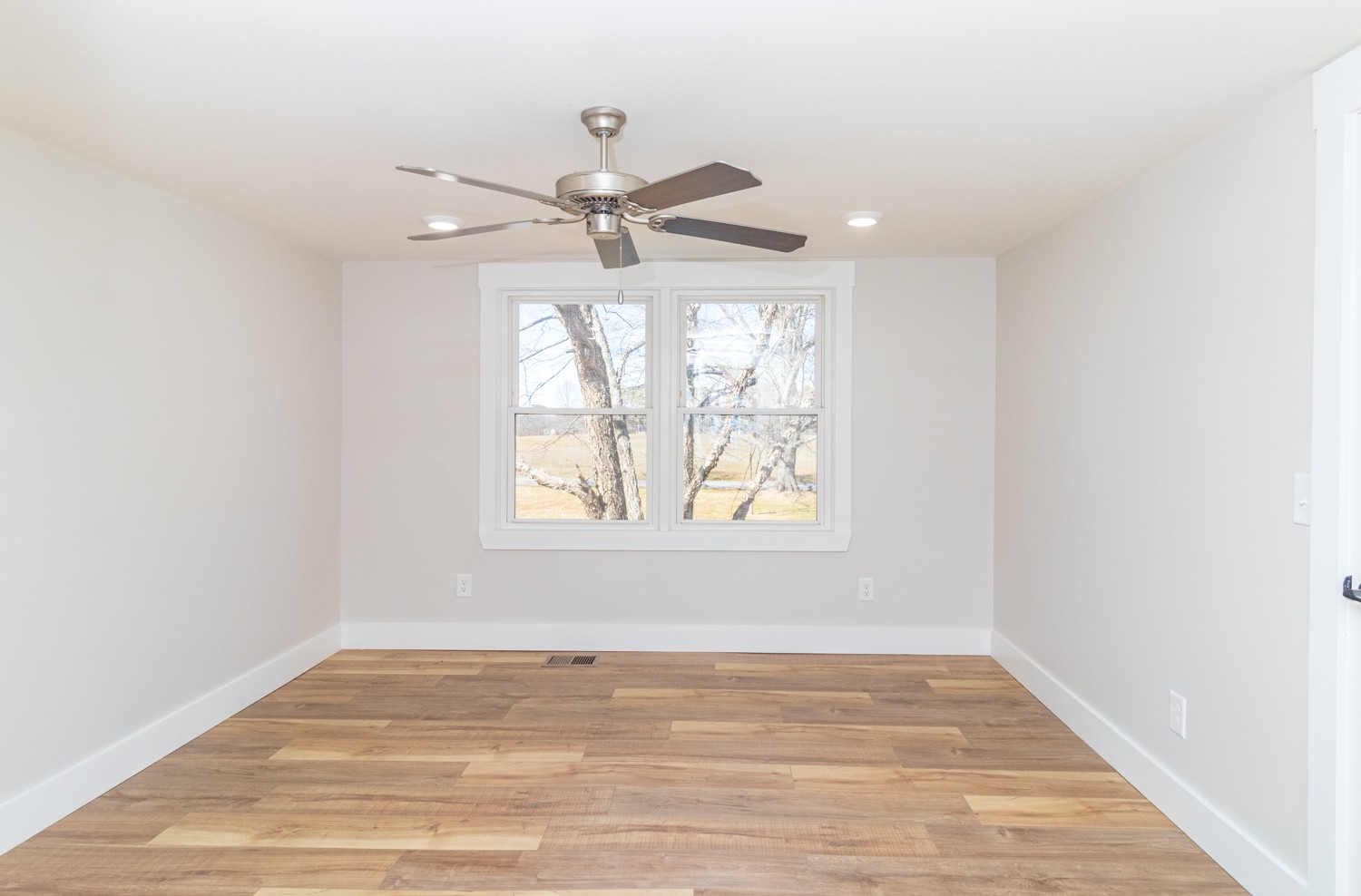 169 Dunn Fall River Road Leoma, TN 38468 - Photo 22 of 34 an empty room with wooden floor fan and windows