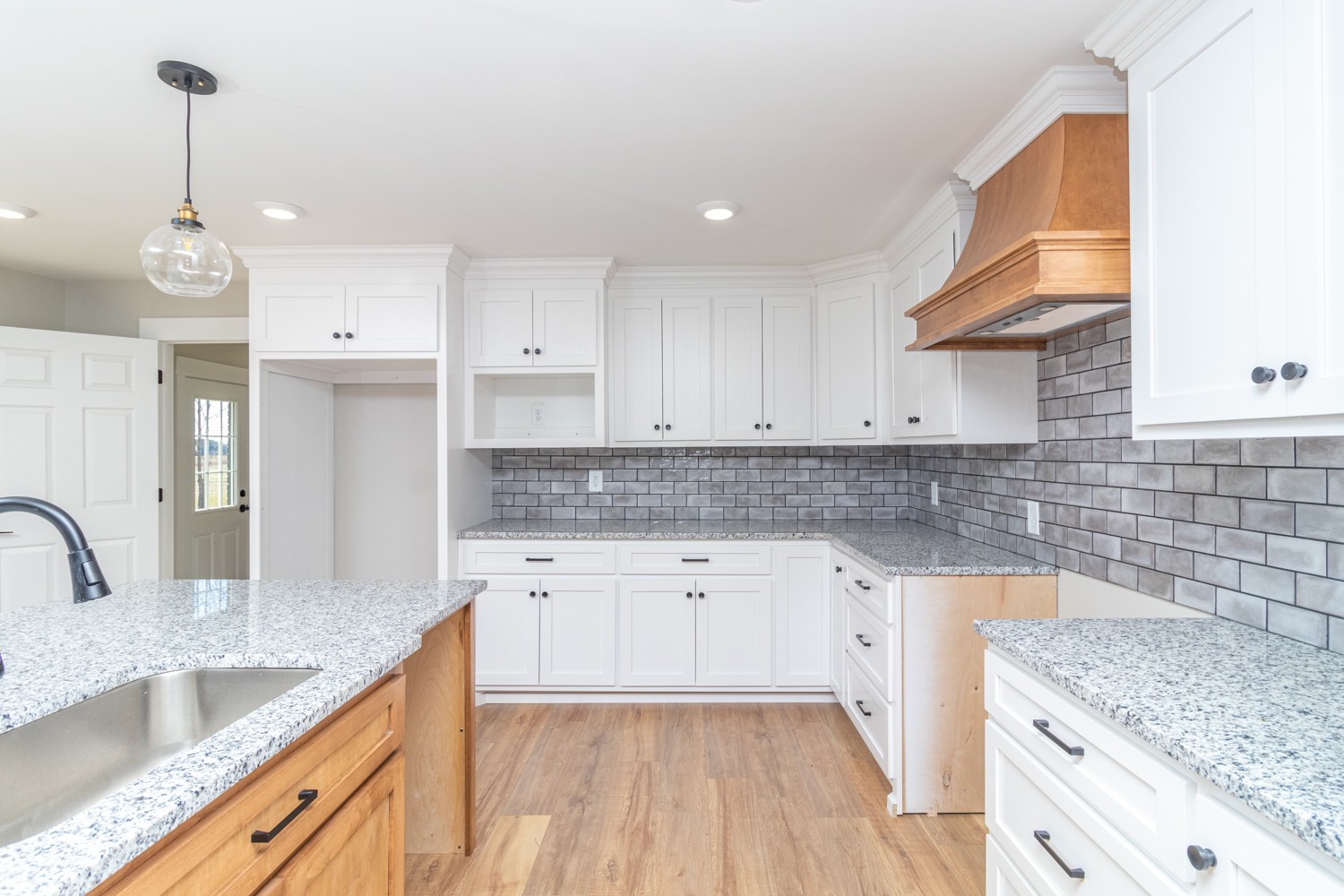 169 Dunn Fall River Road Leoma, TN 38468 - Photo 6 of 34 a kitchen with granite countertop a sink stainless steel appliances and cabinets