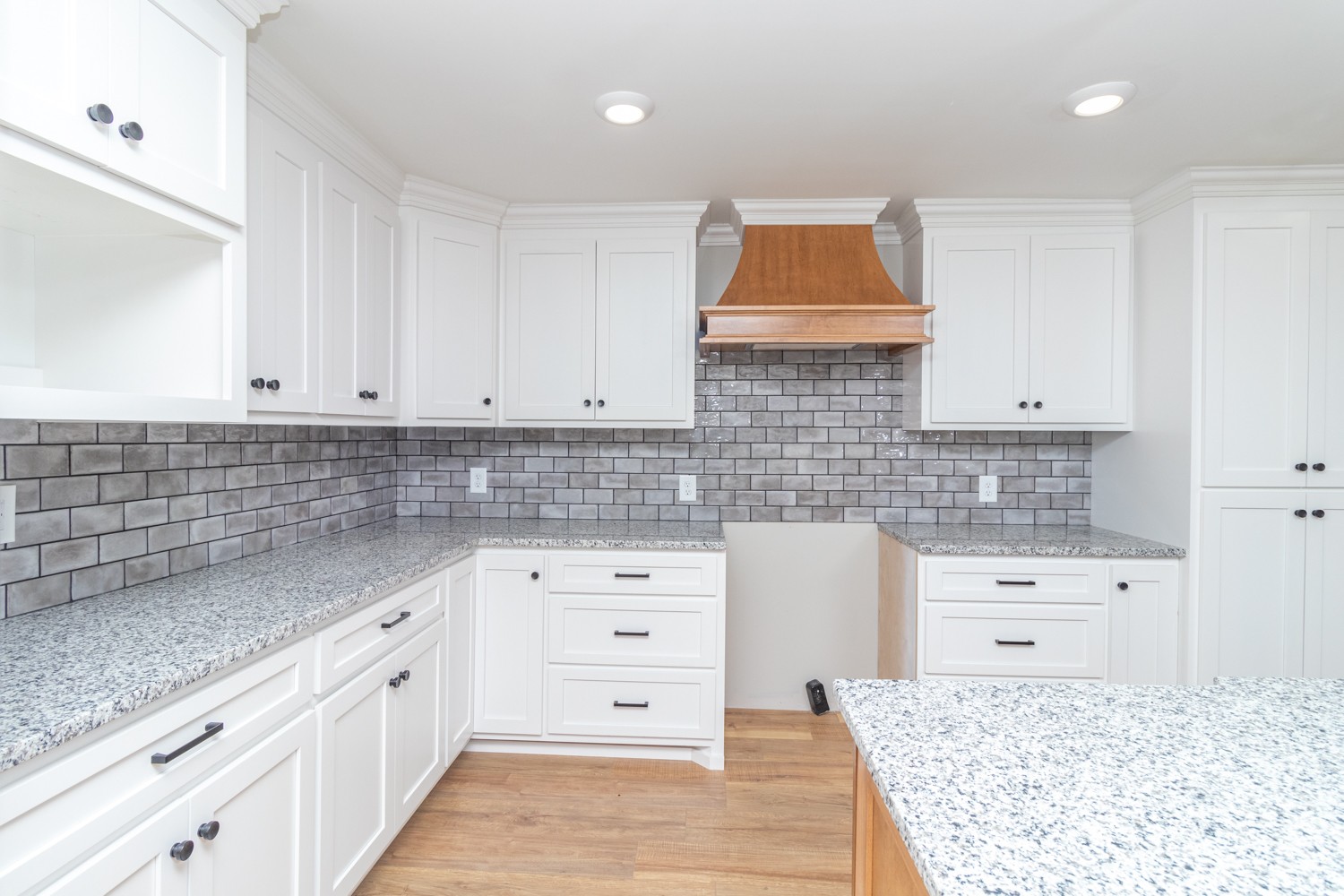 169 Dunn Fall River Road Leoma, TN 38468 - Photo 7 of 34 a kitchen with granite countertop white cabinets and sink