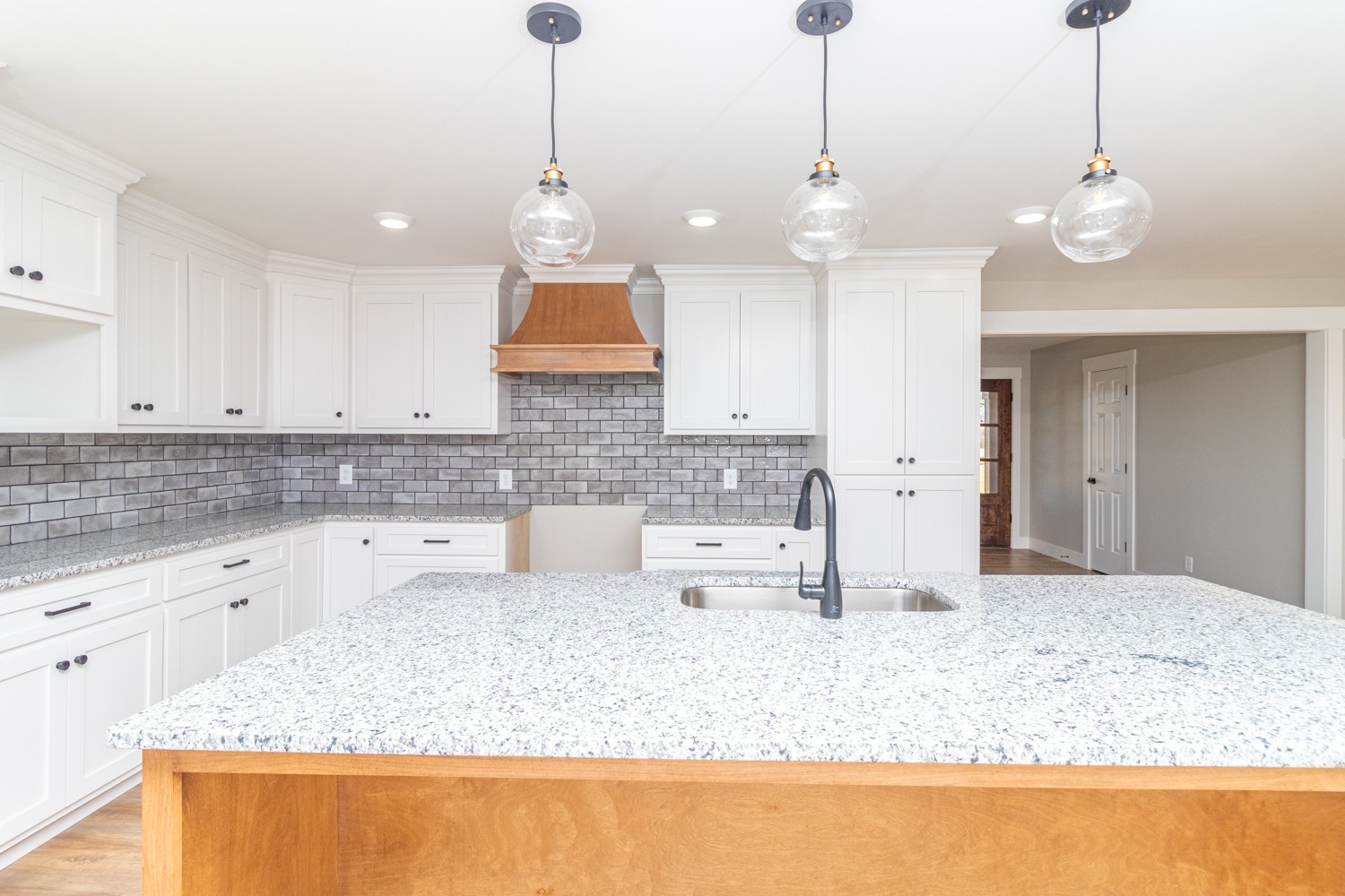 169 Dunn Fall River Road Leoma, TN 38468 - Photo 8 of 34 a large kitchen with kitchen island granite countertop a sink a counter and cabinets