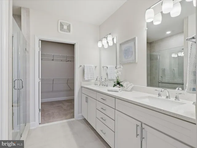 a bathroom with double sink and a mirror