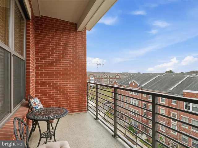 a view of a balcony with a couple of chairs