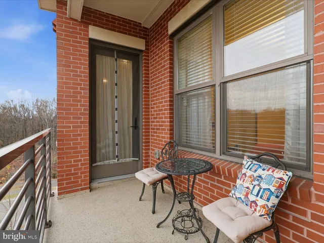 a view of a two chairs in the balcony