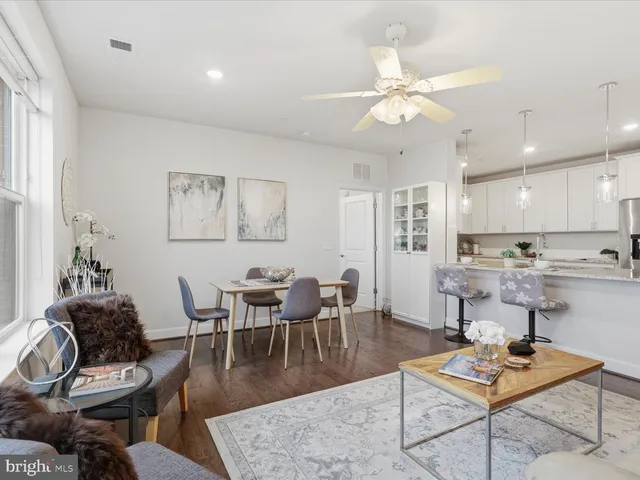 a living room with furniture and view of kitchen