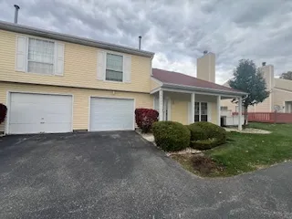 a view of a house with a yard and garage