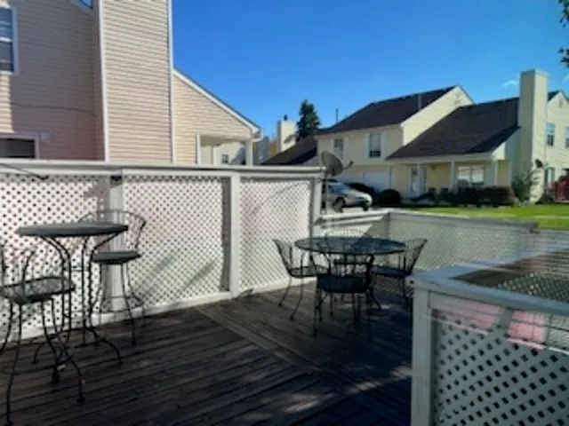 a view of a patio with table and chairs