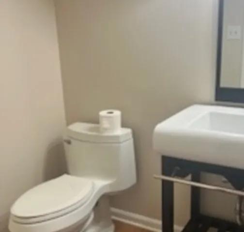 a white toilet sitting next to a white sink