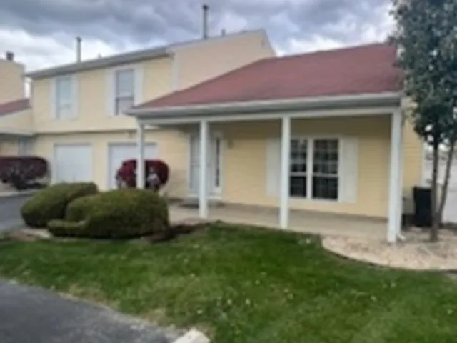 a view of a house with a garden and plants