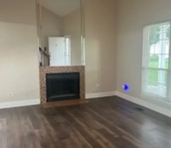 a living room with a fireplace and a wooden floor