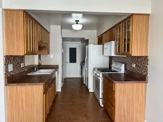 a kitchen with a stove top oven sink and cabinets