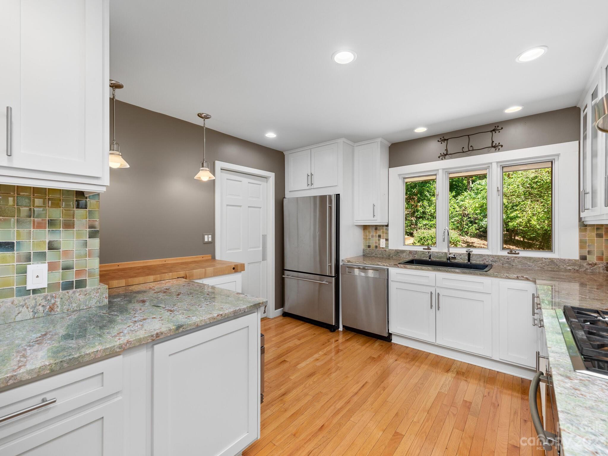 2481 Red Fox Road Tryon, NC 28782 - Photo 14 of 37 a kitchen with stainless steel appliances granite countertop a refrigerator and a sink
