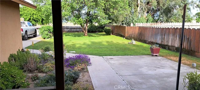 a view of a backyard with fence