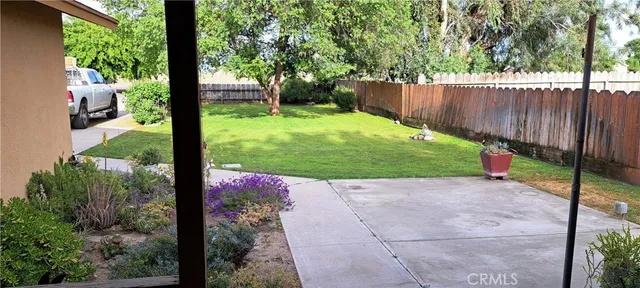 a view of a backyard with fence