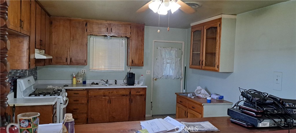 281 North Pine Street Pixley, CA 93256 - Photo 10 of 14 a kitchen with stainless steel appliances granite countertop a stove refrigerator and cabinets