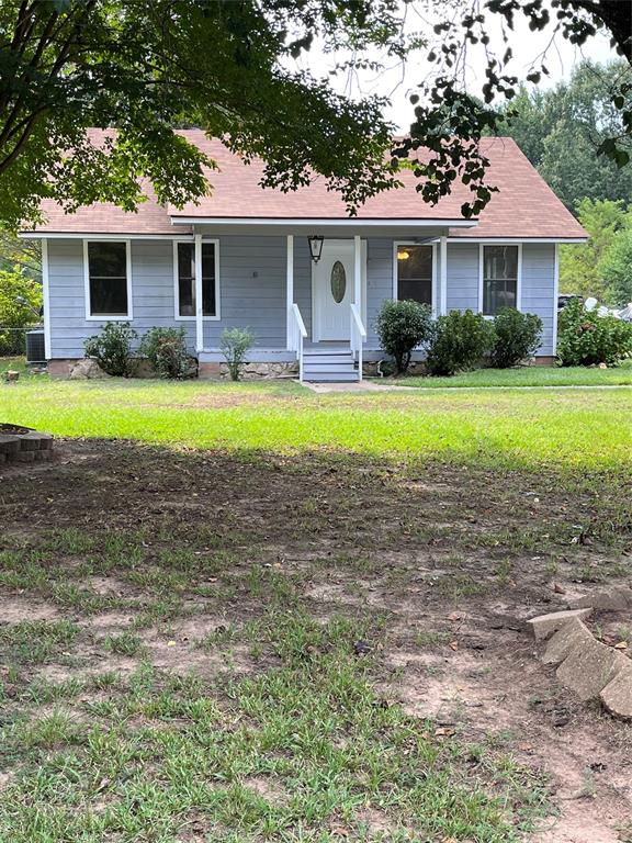 a front view of house with yard and outdoor seating