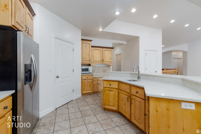 2327 Bluff Ridge Drive Syracuse, UT 84075 - Photo 16 of 66 Kitchen featuring wood cabinetry, light-toned countertops, a stainless steel sink with a gooseneck faucet, recessed lighting, and tiled flooring