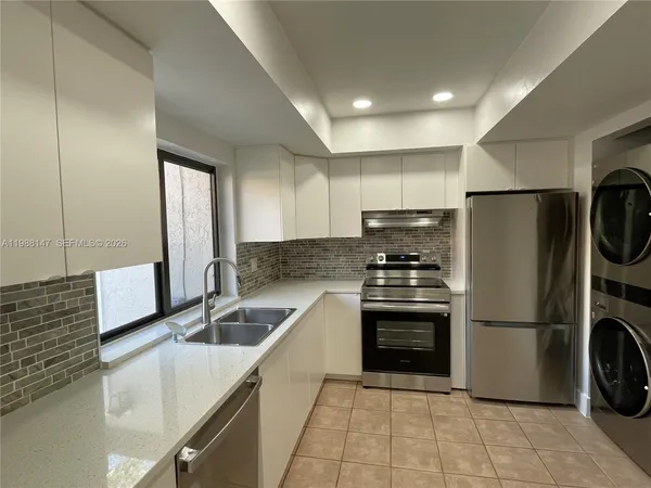 a kitchen with a sink a refrigerator and a sink