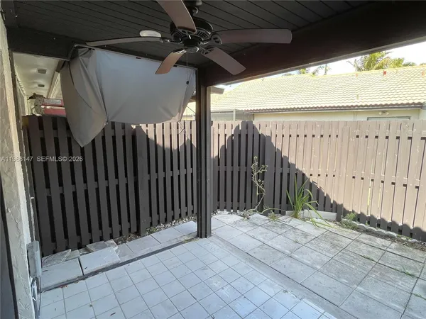 a view of a backyard with wooden fence