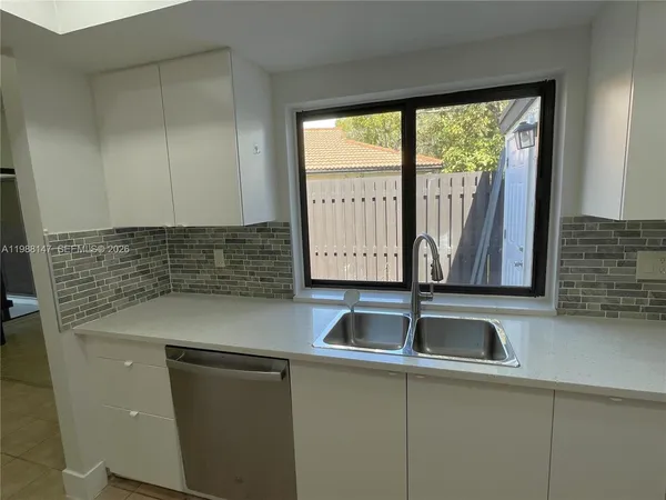 a kitchen with a sink and wooden cabinets