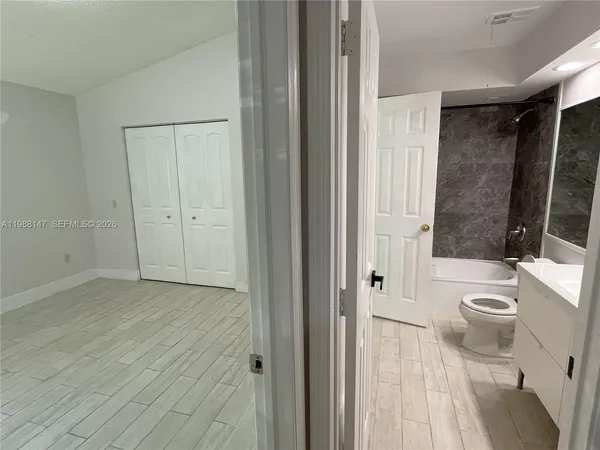 a bathroom with a toilet a sink and a shower