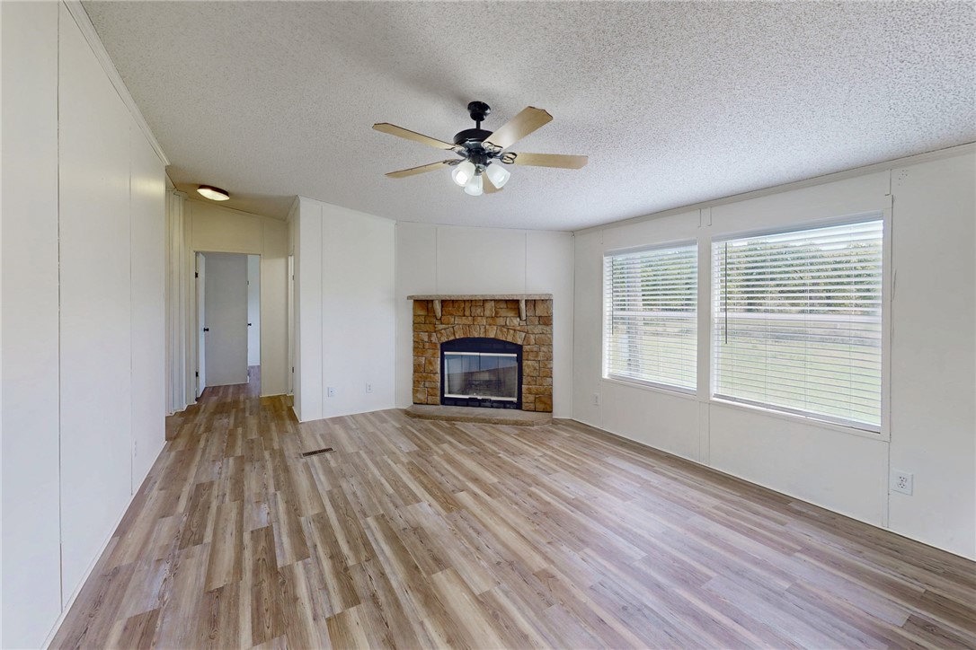 11459 Winstead Lane Calvert, TX 77837 - Photo 10 of 37 an empty room with windows and fireplace