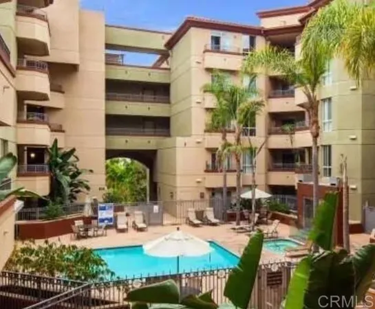 a view of a house with backyard sitting area and swimming pool