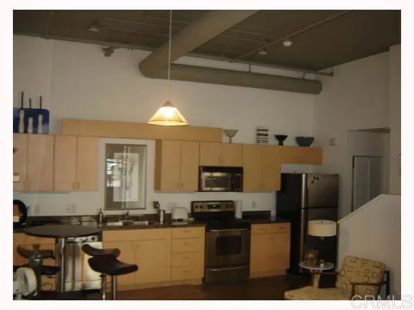 a kitchen with kitchen island granite countertop a stove and cabinets