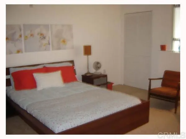 a bedroom with a bed and chair