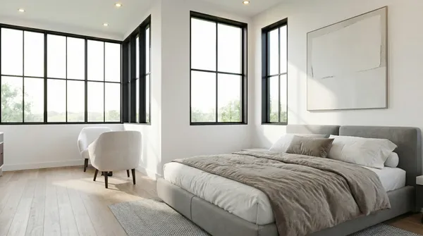 a bedroom with a large window and a couch