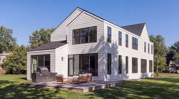 a view of a house with backyard porch and sitting area