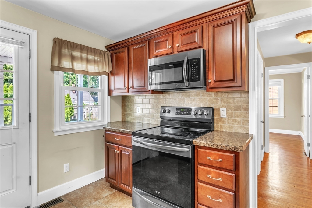 168 Ellsworth Avenue Springfield, MA 01118 - Photo 8 of 38 a kitchen with stainless steel appliances granite countertop a stove and a microwave