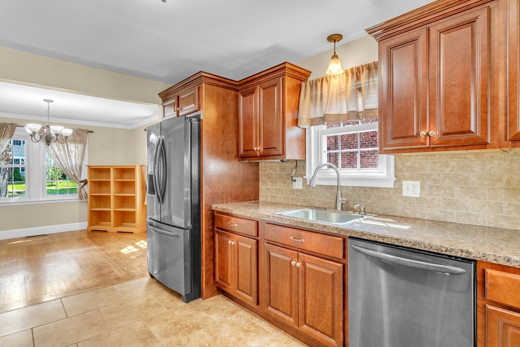 168 Ellsworth Avenue Springfield, MA 01118 - Photo 9 of 38 a kitchen with stainless steel appliances granite countertop a refrigerator and a sink