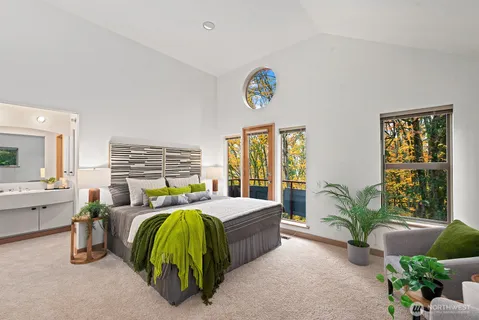 a spacious bedroom with a bed and window