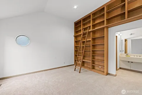 a view of an empty room with cabinet and a window