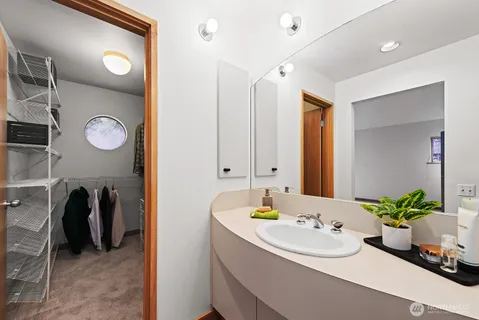 a bathroom with a tub sink and mirror