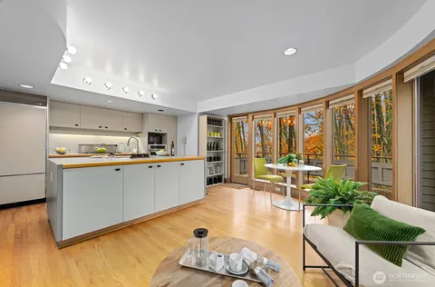 a kitchen with furniture and large windows