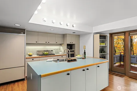 a kitchen with stainless steel appliances a sink and cabinets