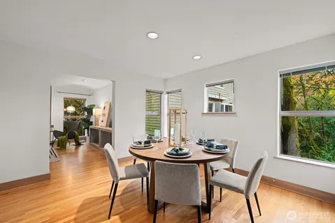 a view of a dining room with furniture and wooden floor