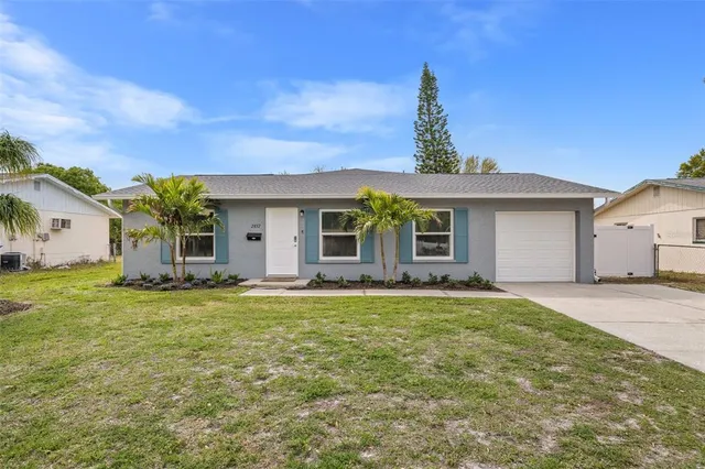 a front view of a house with a garden