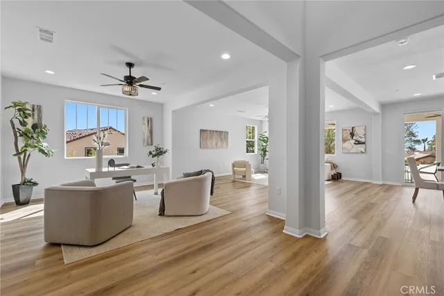 a living room with furniture and wooden floor