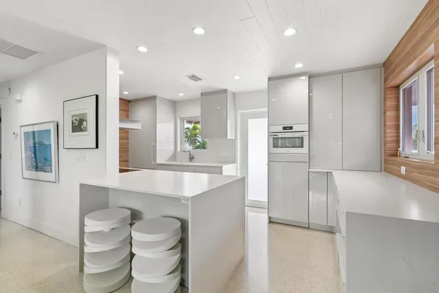 a large kitchen with a large counter top appliances and cabinets