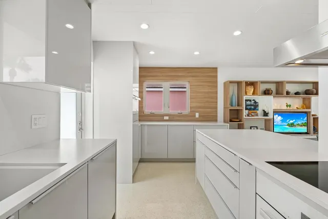 a kitchen with cabinets and window