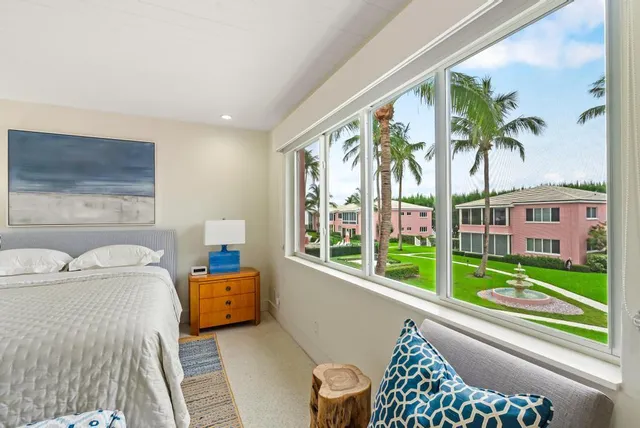 a bedroom with furniture and a large window