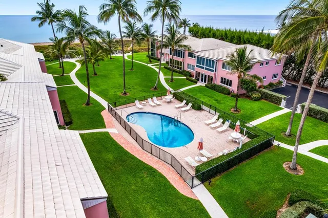 an aerial view of a house with a garden and swimming pool