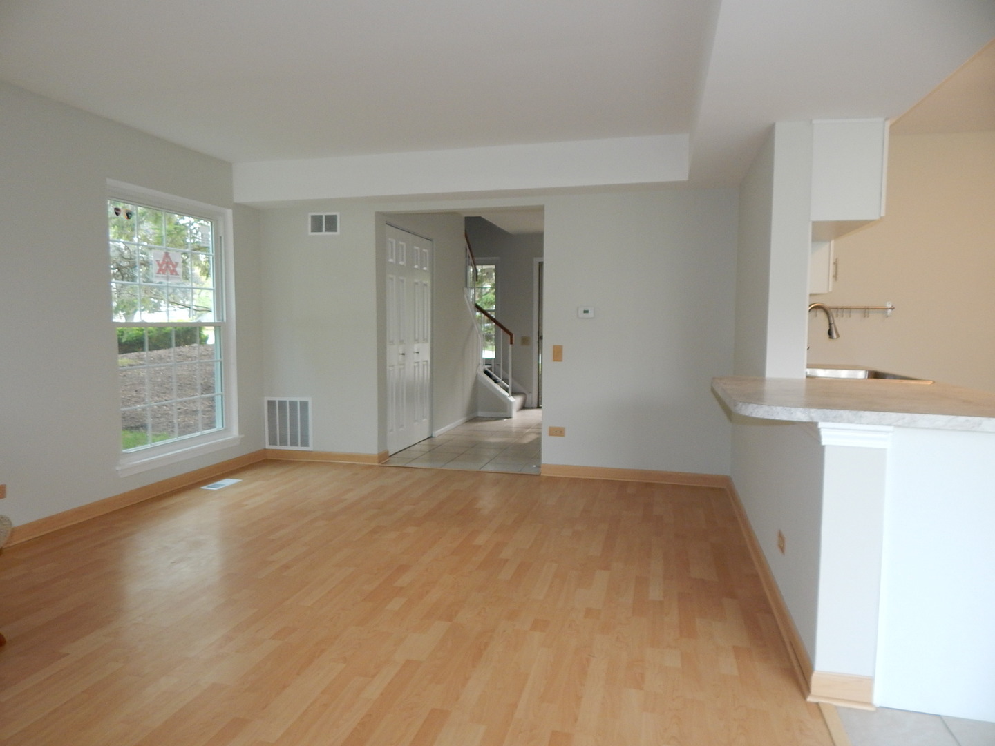 1 North Oltendorf Road Streamwood, IL 60107 - Photo 4 of 18 a view of empty room with wooden floor and fan