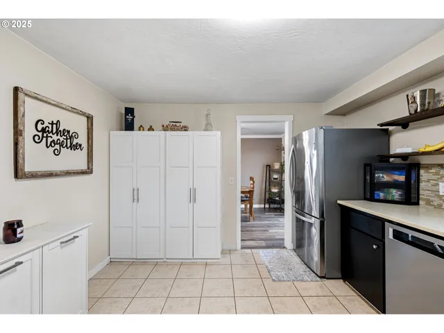 a open kitchen with cabinets and stainless steel appliances
