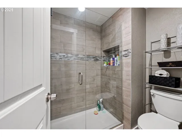 a bathroom with a shower and a toilet