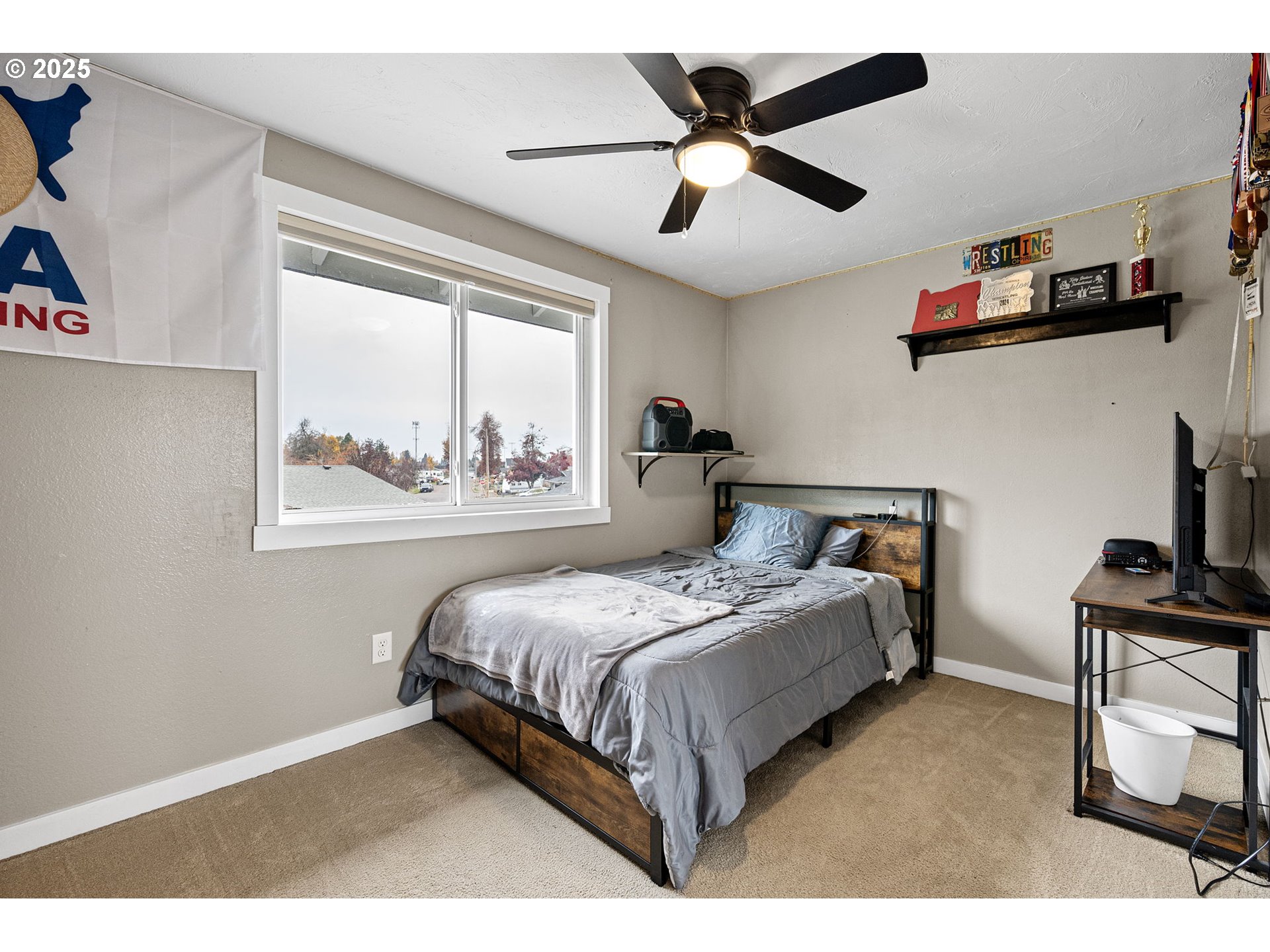 296 65th Street Springfield, OR 97478 - Photo 20 of 33 a bedroom with a bed a window and painting on the wall