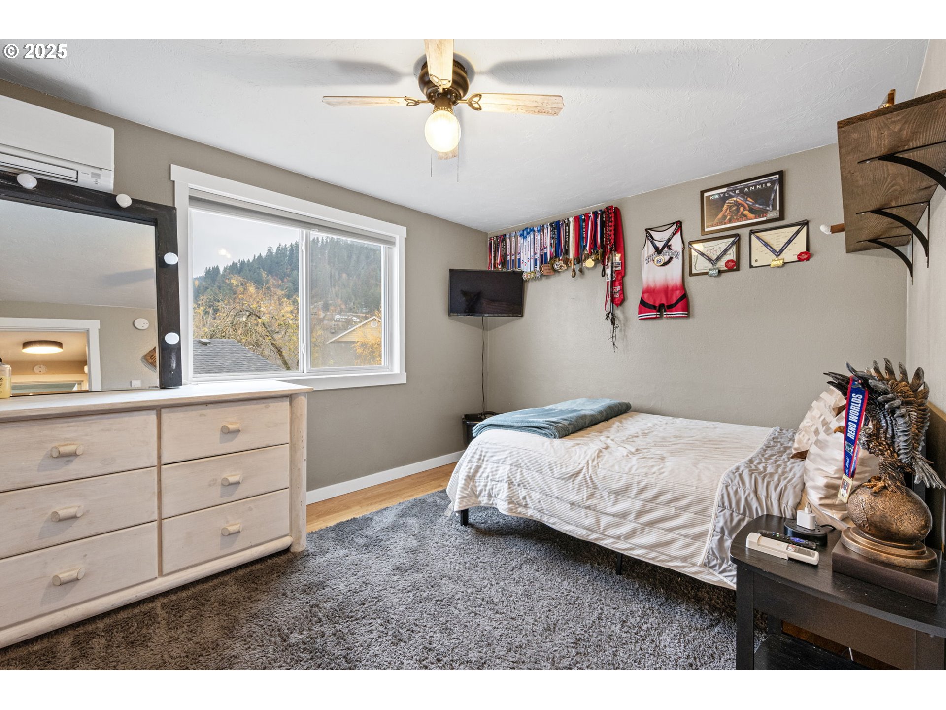 296 65th Street Springfield, OR 97478 - Photo 21 of 33 a bedroom with a bed and a chandelier